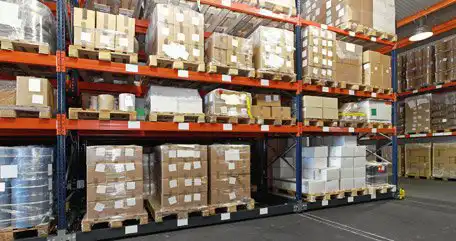 third party logistics warehouse full of boxes stacked neatly on pallets and shelves for shipping